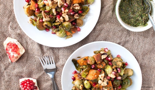 A roasted side dish fit for fall with Brussels sprouts and sweet potatoes with a fall-friendly pesto and walnuts.