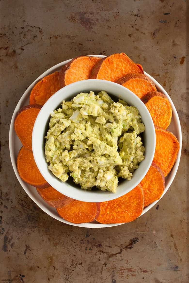 A paleo and avocado twist on egg salad on crackers perfect for snacking, entertaining, or a meal. | Huevocado Sweet Potato Toasts from small-eats.com 