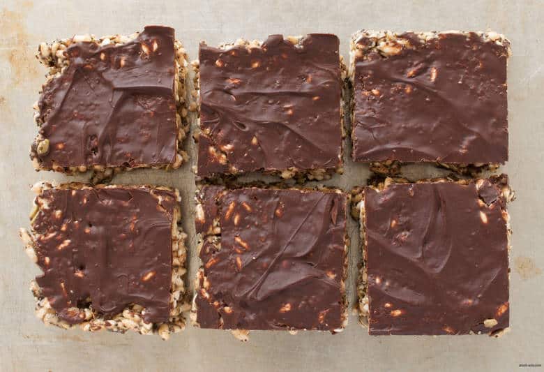 A nut free rice crispy treat packed with healthy seeds and topped with a luxurious layer of chocolate. | Tahini Rice Crispy Treat from small-eats.com