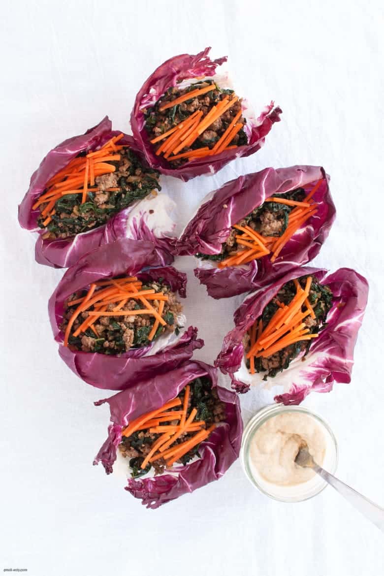A portable, grain-free way to enjoy ground beef that's also packed with greens and carrots, topped with a tahini dressing. | Beef Radicchio Cups with Tahini Dressing from small-eats.com