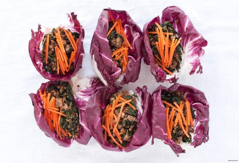 A portable, grain-free way to enjoy ground beef that's also packed with greens and carrots, topped with a tahini dressing. | Beef Radicchio Cups with Tahini Dressing from small-eats.com 