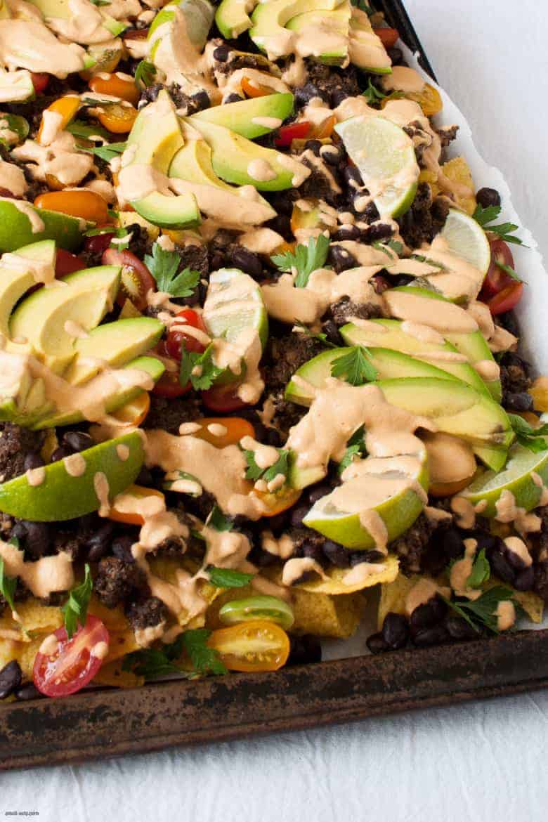 Get your nacho on with these vegan friendly nachos, topped with a cheesy vegan sauce. | Vegan Sheet Pan Nachos from small-eats.com