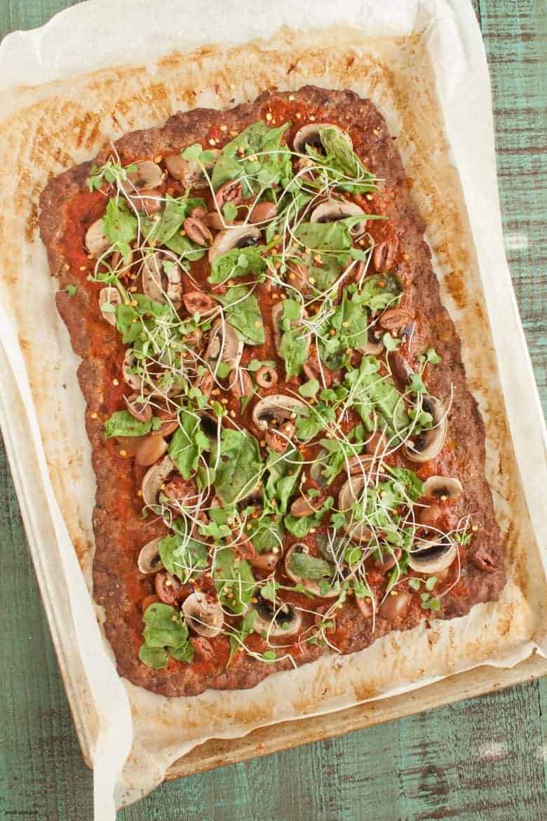 A gluten, dairy and grain free spin on the ultimate meat-lovers pizza, topped with spinach, olives, greens and mushrooms. | Spinach Mushroom Meatza from small-eats.com 