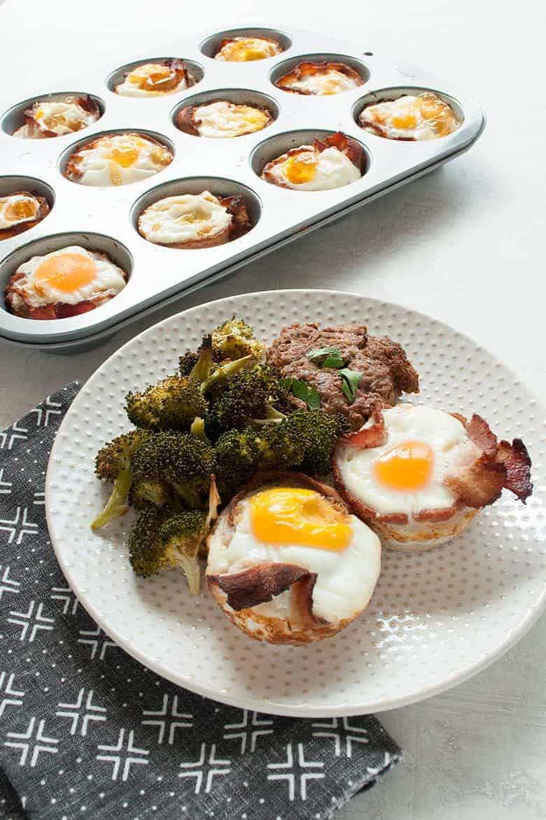 A hearty savory breakfast with eggs, bacon and sausage that's portable, easy to make, and gluten, grain, and dairy free. | Bacon and Egg Muffins with Breakfast Sausage (Gluten Free, Dairy Free) from small-eats.com