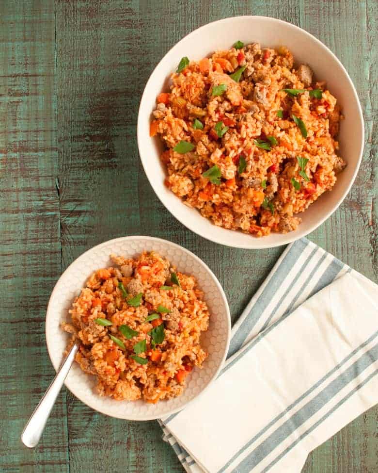 Enjoy a quick and flavorful jambalaya meal that can be made in one pot from Linda Kurnaidi's latest cookbook, 5-Ingredient One Pot Cookbook: Easy Dinners from Your Skillet, Dutch Oven, Sheet Pan & More. | Italian Sausage Jambalaya from small-eats.com