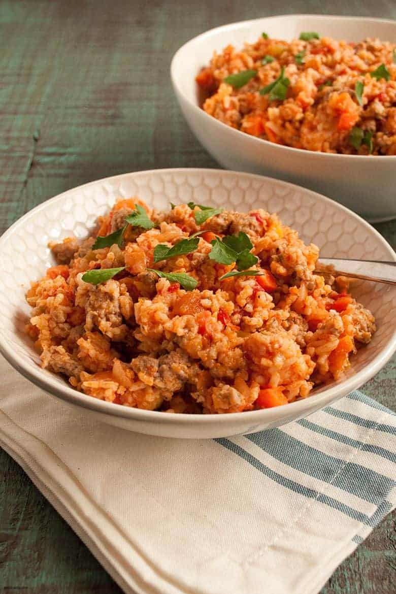 Enjoy a quick and flavorful jambalaya meal that can be made in one pot from Linda Kurnaidi's latest cookbook, 5-Ingredient One Pot Cookbook: Easy Dinners from Your Skillet, Dutch Oven, Sheet Pan & More. | Italian Sausage Jambalaya from small-eats.com